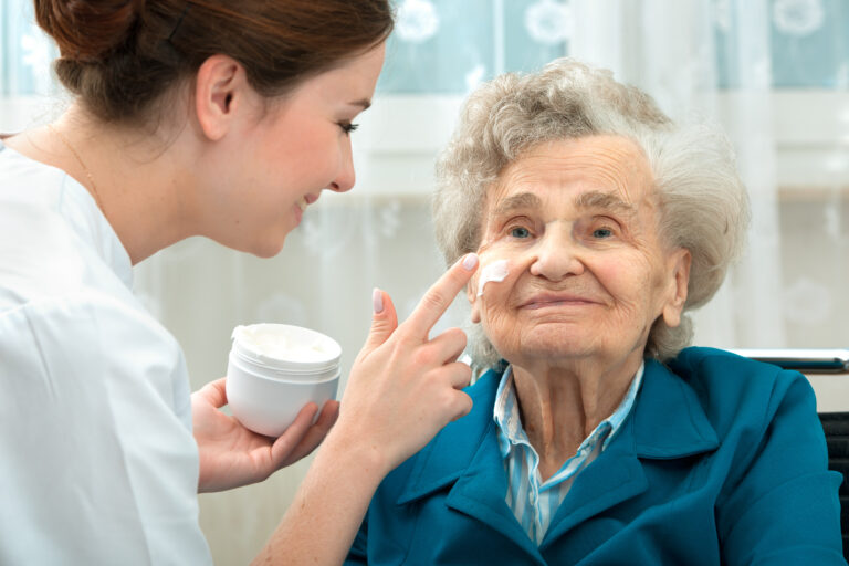 Elderly woman is assisted by nurse at home